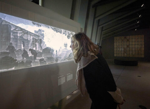 F | FROTEUFEL | Foto: Nikolaus Frank Frau betrachtet ein Papier-Diorama.