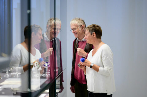 GRIMMWELT Kassel | Permanent Exhibiton | Photo: Sascha Mannel 2 people look at the Grimms' legacy.
