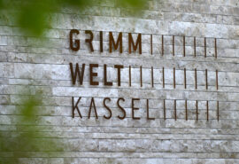 04. GRIMMWELT Kassel | Ein Publikumsmagnet in Nordhessen, der Heimat der Brüder Grimm. Grimmwelt Logo an der Fassade des Gebäudes